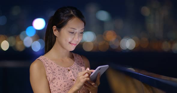 Woman use mobile phone at night