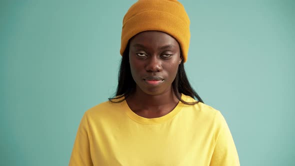 Smiling African woman opening eyes at the camera