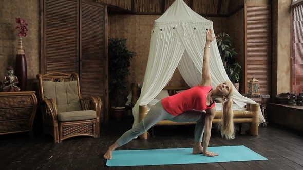 Blond Lady Is Having Yoga Training in the Morning in Her Bedroom.