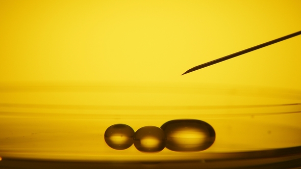 Petite Dribs of Water Trickle From a Needle and Forming a Small Pool in a Lab