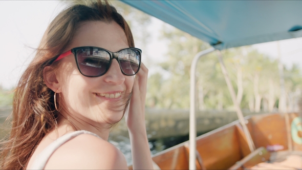 Happy Tourist Woman Enjoying Travelling on Boat in Ancient Tropical Village