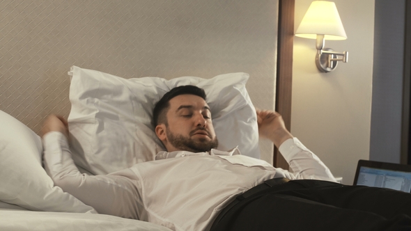 Tired Businessman Taking Rest on Bed