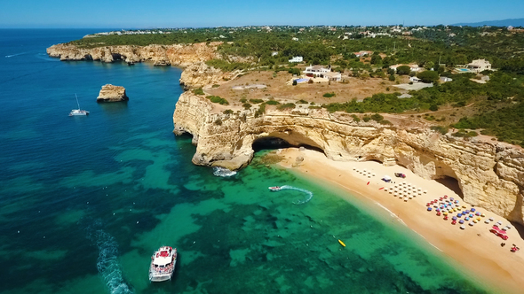 Aerial View of Praia da Marinha Beach with Caves, Sea, Sailing Boats in Portugal