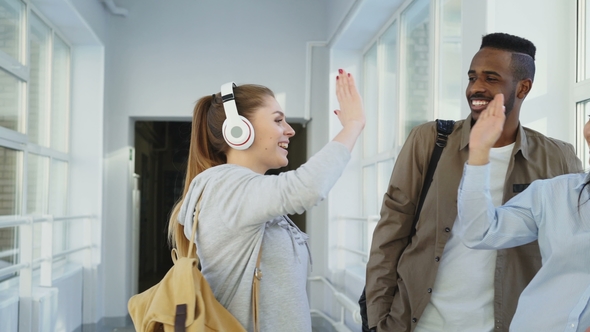 Four Male and Female Student of Differnt Ethnicity Standing Near Window in Wide