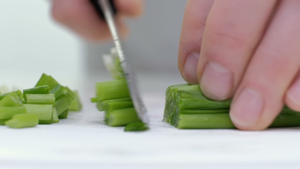 Cut the Green Onions with a Knife on the Board. Cutting Green Without Hands in the Frame. Chef Cuts