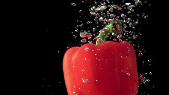 Super Slow Motion One Red Bell Pepper Under Water with Air Bubbles