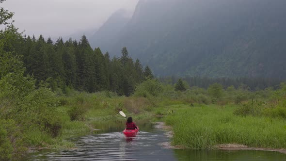 Adventure Caucasian Adult Woman Kayaking in Red Kayak