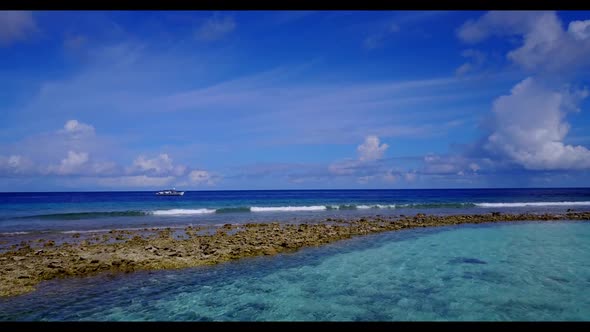 Aerial flying over landscape of perfect coast beach vacation by transparent lagoon and bright sandy 