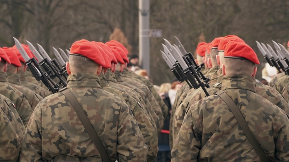 A Lot of Soldiers in Red Berets and Green Uniform Stand with Their Backs To the Camera