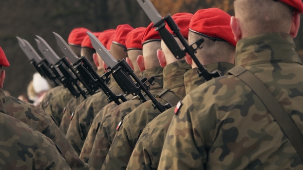 Soldiers with Machine Guns and Bayonet Knives Stand in a Row, in Red Berets