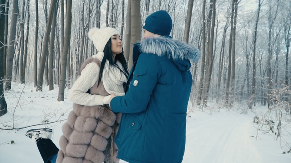 Couple Walking through the Winter Forest