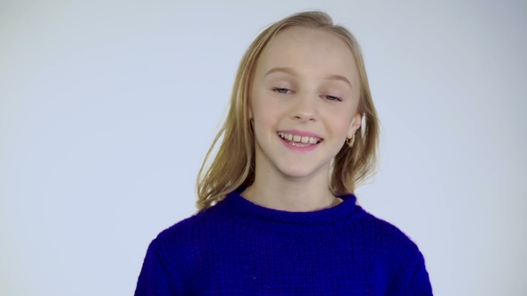 Portrait of Happy Girl with Bright Eyes and Smile Looking at Camera