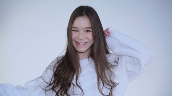 Portrait of Absolutely Happy Girl with Bright Eyes Dancing at Camera