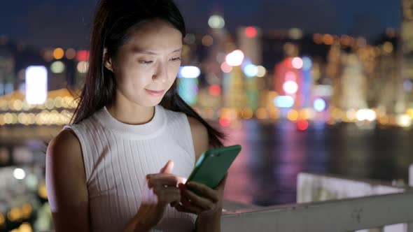 Woman use of mobile phone at night