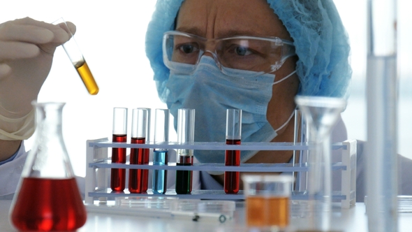 Lab Technician Controls Chemical Substances in Test Tubes