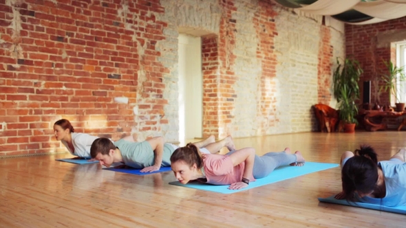 Group of People Making Yoga Exercises in Gym 35