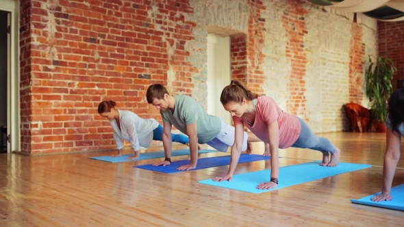 Group of People Making Yoga Exercises in Gym 34