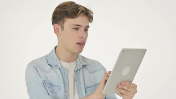 Young Man Reacting to Loss on Tablet on White Background