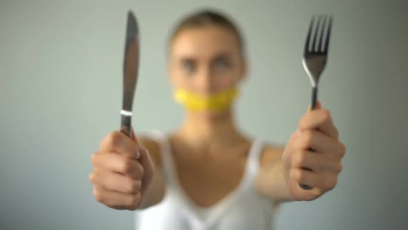 Girl Holding Fork and Knife, Mouth Closed With Tape-Line, Food Restriction