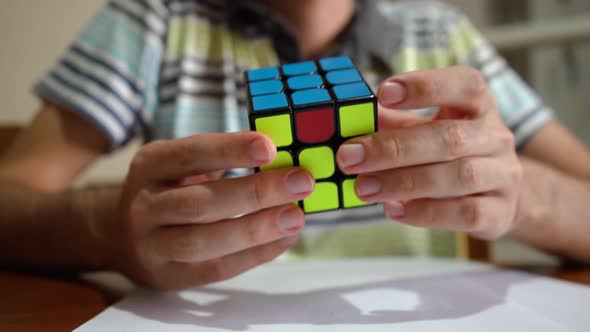 Man Playing And Solving Rubik's Cube. - close up