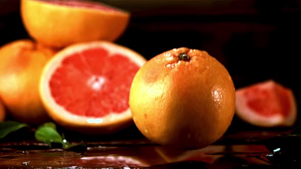 Super Slow Motion Fresh Grapefruit Falls on the Table with Splashes of Water