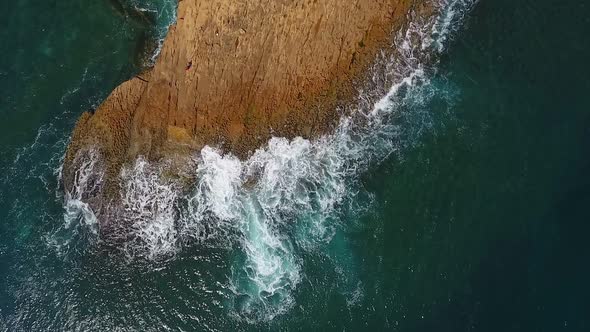 Nostalgic Aerial Video in Slow Motion of the Sea the Waves Smoothly Roll on the Rocky Shores of the