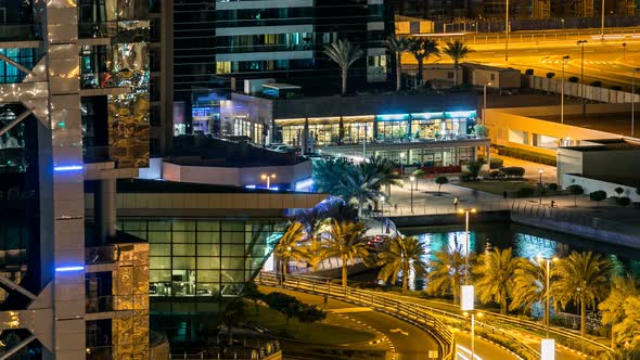 Buildings of Jumeirah Lakes Towers with Traffic on the Road Night Timelapse