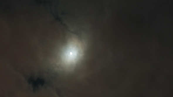 Full Moon and Clouds in Night Sky. .