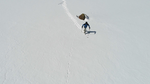 Skier Walking in the Snowy Summit Mountains