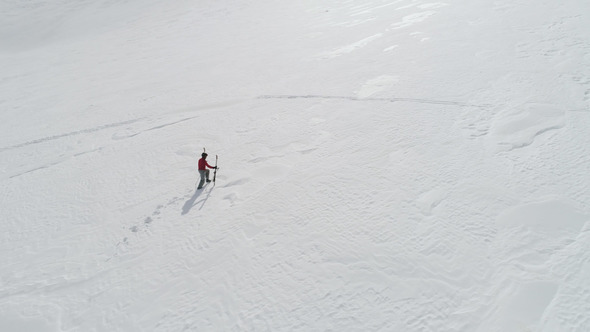 Skier Hiking to Mountain Summit