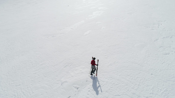 Skier Hiking to Mountain Summit