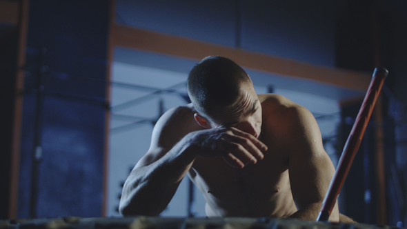 Tired Man Working Out with Sledgehammer