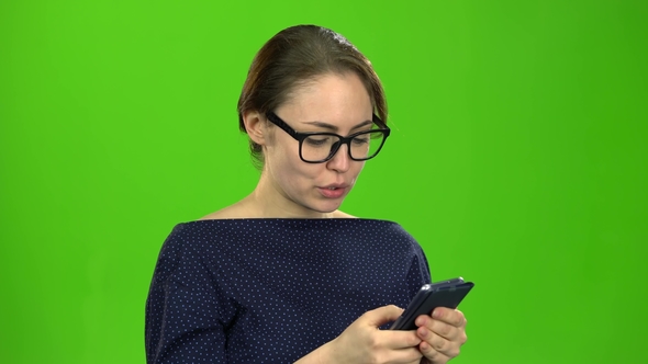 Girl Holding a Phone Dials a Message and Paces