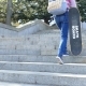 A Girl Climbs the Steps and Holds a Skateboard in Her Hand - VideoHive Item for Sale
