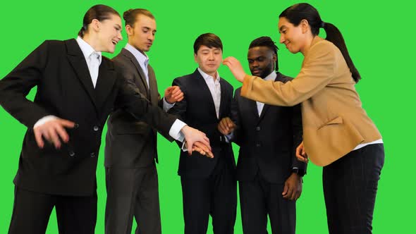 Young Colleagues Fold and Raise Arms Together on a Green Screen Chroma Key