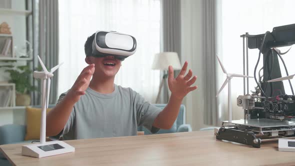 Boy Sitting At The Table And Wearing Vr Glasses While Experimenting With Wind Turbine Model At Home