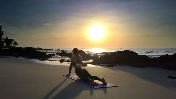 Slim Woman in Snake Assana on Beach