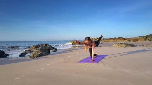 Girl Does Yoga Assana against Ocean Waves Upper View
