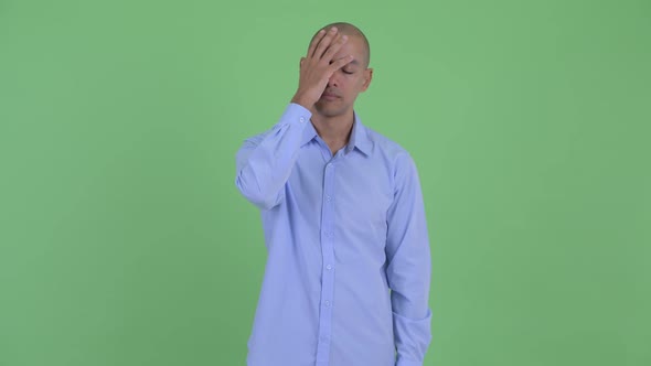 Stressed Bald Multi Ethnic Businessman Showing Face Palm Gesture