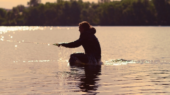 Man Start Wakebording at Sunset. Extreme Lifestyle. Riding on Water