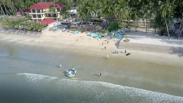 Waves Roll on Palm Beach with the Hotel's Men near Boat