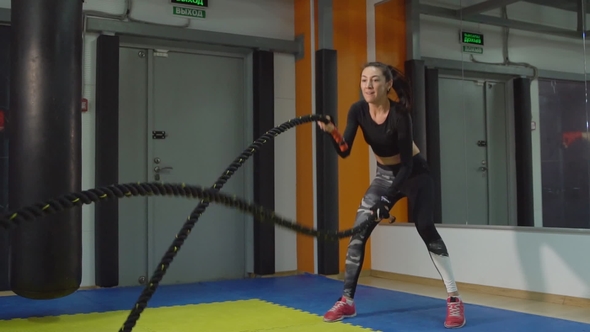  Beautiful Woman Engaged with Ropes in the Gym