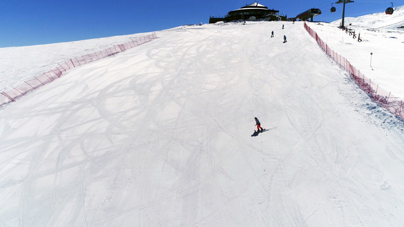 Skiing And Snowboarding On A Slope