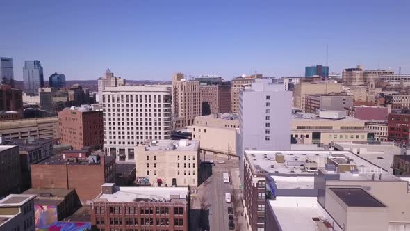 Buildings and streets in sunlight in Grand Rapids, MI, forward aerial