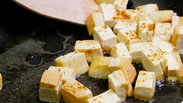 Fried Tofu with Spices on a Cast-iron Pan, Healthy Ingredient for Cooking Vegetarian Dietary
