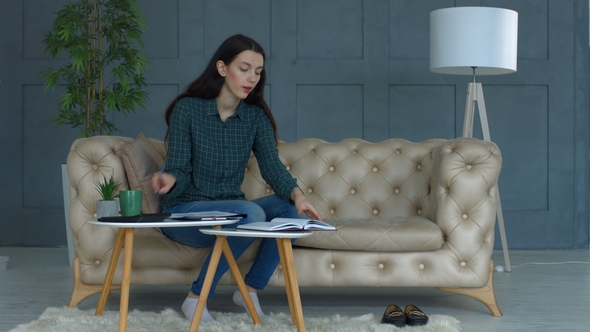 Busy Young Woman Doing Domestic Accounting at Home