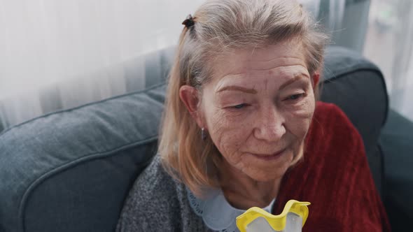 Elderly Woman Using Oxygen Mask at Her Home