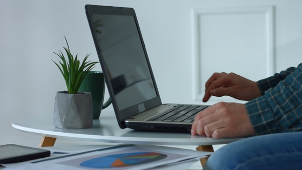 Female Hands Typing on Laptop Keyboard in Home Office