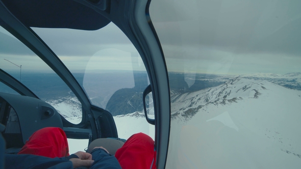 Helicopter Cockpit Flies in Winter Mountains