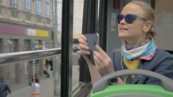 Woman traveling in city by double-decker bus